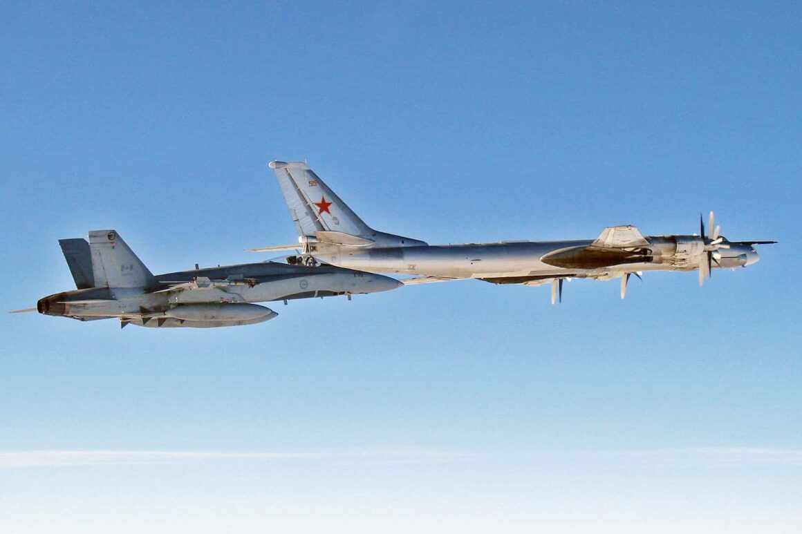 Tu-95 bomber escorted by a Royal Canadian Air Force CF-18 fighter