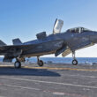 A U.S. Marine Corps F-35B fighter jet lands on the Japanese aircraft carrier JS Kaga