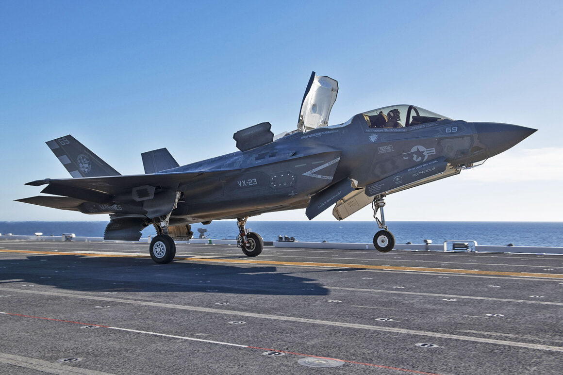 A U.S. Marine Corps F-35B fighter jet lands on the Japanese aircraft carrier JS Kaga