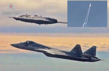 A Su-57 fighter jet flies alongside the S-70 drone and in detail the aircraft is being hit by a missile