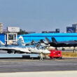 Su-57 fighter and an F-35 landing in the background