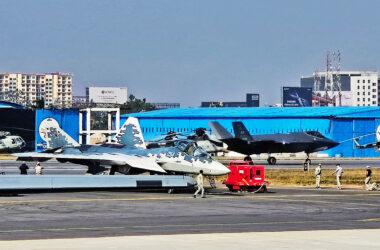 Su-57 fighter and an F-35 landing in the background